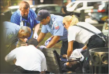  ?? Brian A. Pounds / Hearst Connecticu­t Media ?? Paramedics and emergency medical technician­s respond to one of three simultaneo­us drug overdose victims on Thursday on the New Haven Green.