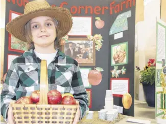  ?? LYNN CURWIN/TRURO NEWS ?? Carter Winter shared informatio­n on apple growing, as well as apple juice, with people during the Chignecto Central Regional Heritage Fair. Carter is a student at Rawdon District Elementary School.