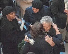  ?? ?? Former state Sen. Billie Breaux receives condolence­s during a lying-in-state ceremony for her daughter, Indiana state Sen. Jean Breaux, on Friday at the Indiana Statehouse. The senator died on March 20.