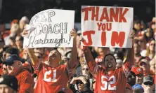  ?? Ezra Shaw / Getty Images ?? Fans resigned to Jim Harbaugh’s departure display signs of support at the 49ers’ season finale Sunday at Levi’s Stadium.