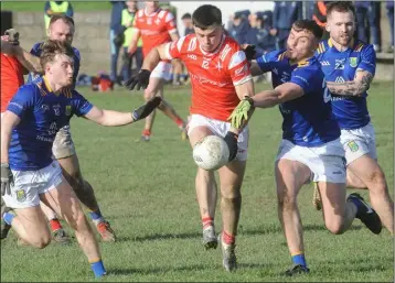  ?? ?? Louth’s Jonathan Commins is challenged by Wicklow’s Gavin Fogarty and Dan Cooney during the O’Byrne Shield final at St. Brigid’s Park. Photos: Aidan Dullaghan/Newspics