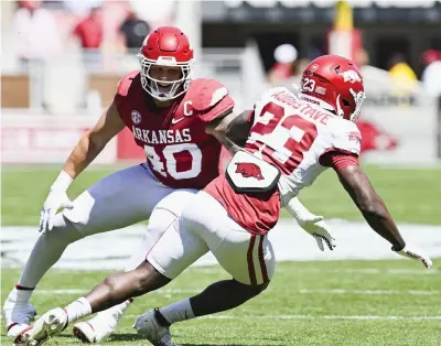  ?? (Photo by Charlie Kaijo/nwa Democrat-gazette) ?? Arkansas defensive lineman Landon Jackson (40) of Texarkana, Texas, covers Arkansas running back Isaiah Augustave (23), Saturday during the first quarter of the the Red-white Spring game at Reynolds Razorback Stadium in Fayettevil­le.