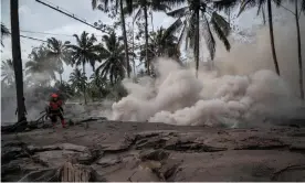  ?? Photograph: AFP/Getty Images ?? Volcanic ash covers part of Sumber Wuluh village in Lumajang, Indonesia, after the Mount Semeru volcano eruption that killed 14.