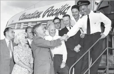  ?? PENTICTON MUSEUM AND ARCHIVES/Special to The Herald ?? Mayor C.E. Oliver greets Canadian Pacific Airlines Capt. Lynn Foslien at Penticton airport. From left are Alex Walton, Mrs. J.H. Crump, Hon. L. Peterson, Mayor Oliver, H.B. Main, J.A. Gray, J.H. Crump, Frank Baker and Capt. Foslien.