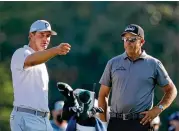  ?? CURTIS COMPTON/CURTIS.COMPTON@AJC.COM ?? Bryson Dechambeau (left) talks with three-time Masters winner Phil Mickelson on the 10th tee during a practice round Wednesday.