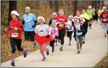  ?? NWA Democrat-Gazette/ANDY SHUPE ?? Runners begin the 2016 “Jingle Bell Jog” and “Reindeer Fun Run” to benefit the Botanical Garden of the Ozarks in Fayettevil­le. The 5K and fun run will take place Saturday at the garden.