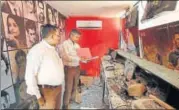  ?? PTI PHOTO ?? ▪ Forensic experts examine the remains of a ticket counter at a cinema hall after it was vandalised in Ahmedabad on Sunday to protest the release of Padmaavat on January 25.