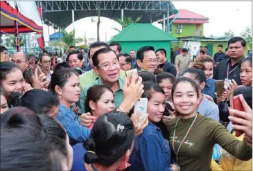  ?? FACEBOOK ?? Prime Minister Hun Sen poses for a photograph with garment workers after an event yesterday in Phnom Penh’s Sen Sok district.