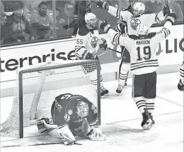  ?? Wally Skalij Los Angeles Times ?? JOHN GIBSON of the Ducks slumps to the ice as Mark Letestu (55) of the Oilers celebrates his goal.