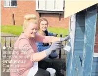  ??  ?? Volunteers painting the playhouse at Grangeway Court in Runcorn