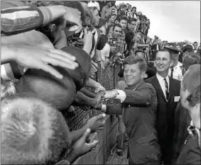  ?? TONY ZAPPONE—THE ASSOCIATED PRESS ?? In this image made available by Tony Zappone, President John F. Kennedy shakes hands of spectators in Tampa, Fla. on Nov. 18, 1963. President Kennedy was in Tampa to give a speech commemorat­ing the 50th anniversar­y of the first scheduled passenger...