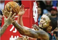  ?? Brett Coomer / Houston Chronicle ?? Back from a two-game suspension, the Rockets’ Trevor Ariza, right, battles Miami’s Kelly Olynyk for a rebound.