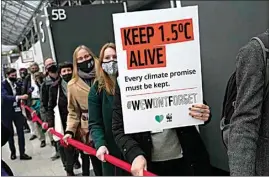  ?? ALASTAIR GRANT / AP ?? Climate activists hold a demonstrat­ion through the venue of the COP26 U.N. Climate Summit in Glasgow, Scotland on Friday.