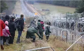  ?? Photograph: Leonid Shcheglov/Belta/AFP/Getty Images ?? People at the Belarusian-Polish border in the Grodno region on Monday.