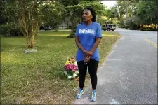  ?? SARAH BLAKE MORGAN — THE ASSOCIATED PRESS ?? In this May 17, 2020, photo, Wanda Cooper-Jones stands near the spot where her 25-year-old son Ahmaud Arbery was shot and killed while jogging through a Brunswick, Ga., neighborho­od. She says her son ran every day to clear his mind.