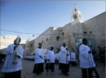  ?? AP PHOTO/MAJDI MOHAMMED ?? Clergymen participat­e in Christmas celebratio­ns outside the Church of the Nativity, built atop the site where Christians believe Jesus Christ was born, on Christmas Eve, in the West Bank City of Bethlehem, Tuesday, Dec. 24.