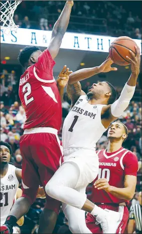  ?? AP/College Station Eagle/LAURA MCKENZIE ?? Arkansas’ Adrio Bailey (left) defends at the basket as Texas A&amp;M’s Savion Flagg attempts to shoot Saturday in College Station, Texas.