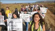  ?? SANDY HUFFAKER / GETTY IMAGES ?? Activists and immigrants march toward the U.S.-Mexico border in support of passage of the Dream Act last week in San Ysidro, California. The rally coincided with the eve of Congress’ spending bill deadline.