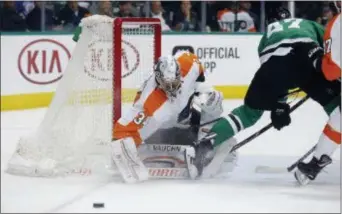  ?? MICHAEL AINSWORTH — THE ASSOCIATED PRESS ?? Flyers goaltender Petr Mrazek (34) deflects a shot by Dallas’ Alexander Radulov (47) during the first period in Dallas on Tuesday.