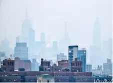  ?? AP PHOTO/JULIE JACOBSON ?? A thick haze hangs over Manhattan in New York. Wildfires in the American West, including one burning in Oregon that’s currently the largest in the U.S., are creating hazy skies as far away as New York as the massive infernos spew smoke and ash into the air in columns up to 6 miles high.