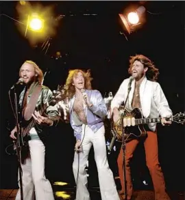  ?? Ed Caraeff Getty I mages/ HBO ?? CHART- TOPPING brothers Maurice, left, Robin and Barry Gibbs perform in 1979 as seen in the f ilm “The Bee Gees: How Can You Mend a Broken Heart.”