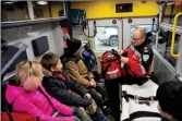  ?? ?? Students take a closer look at the interior of an ambulance with Theo Erasmus, an advanced care paramedic with Hutch Ambulance in Swift Current.