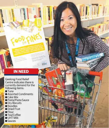  ?? Picture: MIKE DUGDALE ?? STOCKING UP: Library operations officer Fiona Chong backs Food for Fines.