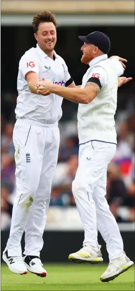  ?? ?? England’s Ollie Robinson, left, celebrates taking the wicket of South Africa’s Marco Jansen, with his captain, Ben Stokes