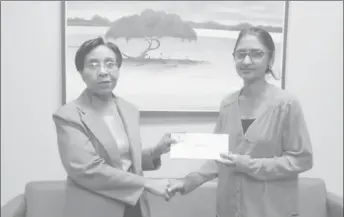  ??  ?? GBTI’s Head of Banking Operations, Collette Lyken-Ramdial (left) handing over the donation to Dr Bibi Alladin-Karan of the New-Born Screening project
