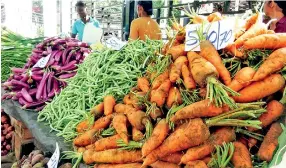  ??  ?? Consumer woes: Veggies going cheap at the economic centre, but prices high at retail outlets