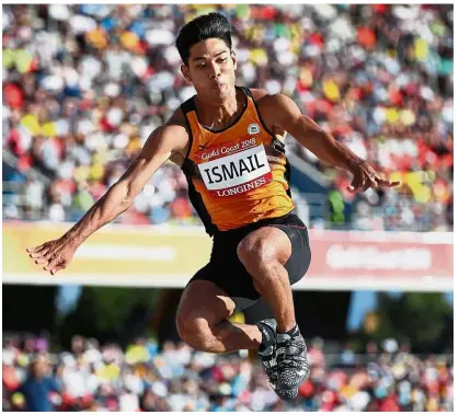  ??  ?? Not good enough: Muhd Hakimi Ismail in action during the men’s triple jump final at the Carrara Stadium yesterday.