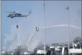  ?? GREGORY BULL — THE ASSOCIATED PRESS ?? Fire crews battle the fire on the USS Bonhomme Richard in San Diego on Monday.