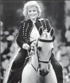  ?? MARK BOSTER/LOS ANGELES TIMES FILE PHOTOGRAPH ?? Zsa Zsa Gabor rides her Tennessee Walking horse “Silver Fox” in the 1988 Huntington Beach Fourth of July Parade.