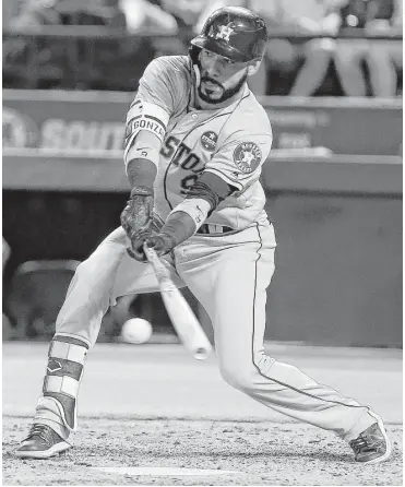  ?? Brandon Wade / Getty Images ?? The Astros’ Marwin Gonzalez goes down to get a low pitch and strokes it into center for a two-run single in the fourth inning Monday night.