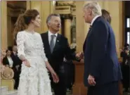  ?? AP PHOTO/ PABLO MARTINEZ MONSIVAIS ?? Argentina’s President Mauricio Macri and his wife Juliana Awada greet President Donald Trump and first lady Melania Trump at the Teatro Colon for the G20leaders dinner Friday in Buenos Aires, Argentina.