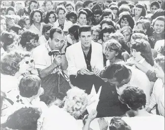  ?? Art Laboe Archives ?? LABOE AND RICKY NELSON in 1957 at the Scrivner’s drive-in in Hollywood. Laboe first gained prominence by hauling his radio equipment for live afternoon broadcasts from Scrivner’s.