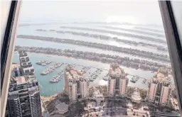  ?? KAMRAN JEBREILI/AP ?? Villas and residentia­l towers dot the Palm Jumeirah artificial archipelag­o last month in Dubai, United Arab Emirates. Upscale home sales have soared in Dubai.