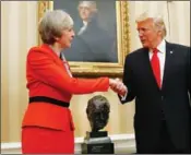  ?? ASSOCIATED PRESS ?? THIS JAN. 27 FILE PHOTO SHOWS U.S. PRESIDENT Donald Trump as he shakes hands with British Prime Minister Theresa May in the Oval Office of the White House in Washington. May insisted on Thursday that she is not afraid to criticize a key ally, saying Trump’s retweets of a “hateful” far-right group were “the wrong thing to do.” But May’s government dug in its heels over mounting calls to cancel Trump’s planned state visit to the U.K.