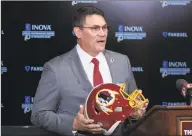  ?? Alex Brandon / Associated Press ?? Redskins head coach Ron Rivera holds up a helmet during a news conference at the team’s training facility in Ashburn, Va., on Jan. 2