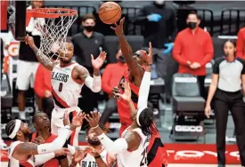  ?? SOOBUM IM/USA TODAY SPORTS ?? Raptors power forward Pascal Siakam (43) shoots the ball as Trail Blazers power forward Robert Covington (23) defends during the second half at Moda Center on Monday.