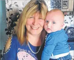  ??  ?? Lorayne Minahan, 49, of Lydd, a young dementia sufferer with her 12-month-old grandson Bradon