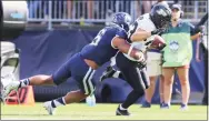  ?? Stew Milne / Associated Press ?? Purdue wide receiver Jackson Anthrop, right, is tackled by UConn linebacker Ian Swenson during the first half Saturday in East Hartford.