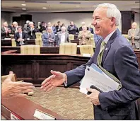  ?? Arkansas Democrat-Gazette/BENJAMIN KRAIN ?? Gov. Asa Hutchinson greets legislator­s Tuesday at a meeting of the Joint Budget Committee. He said his budget proposal “is conservati­ve in spending, increases our savings and invests in the future.”