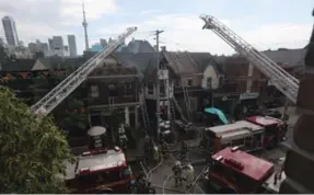  ?? RICHARD LAUTENS/TORONTO STAR ?? Toronto Fire dispatched 44 trucks and 30 crews to Ryu’s Noodle Bar at 33 Baldwin St. on Friday afternoon. The fire was declared under control and downgraded to a two-alarm by 4 p.m.