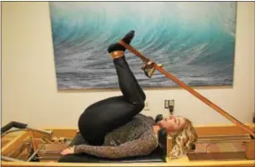  ?? ANNE NEBORAK — DIGITAL FIRST MEDIA ?? Angel Bigas uses classical Pilates methods during private lessons at Evolution — Be More Than Human.