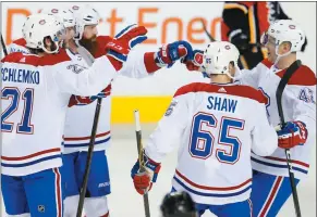  ?? CP PHOTO TODD KOROL ?? Montreal Canadiens’ Jordie Benn, centre, celebrates his goal with teammates Byron Froese (42), Andrew Shaw (65), David Schlemko (21) and Alex Galchenyuk (27) during first period NHL hockey action against the Calgary Flames, in Calgary on Friday.