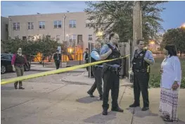  ?? | ASHLEE REZIN/ SUN- TIMES ?? Chicago Police secure the scene in the 1800 block ofWest Maypole, where a 41- year- old man was found shot to death early Sunday.