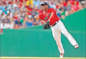  ?? [MICHAEL DWYER/THE ASSOCIATED PRESS] ?? Boston’s Rafael Devers throws out a runner at first base during Saturday’s game against New York.