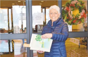  ?? MONICACABR­ERA/THE MORNING CALL ?? Kathy Dempsey holds a long-lost scrapbook in the foyer of Country Meadows Nursing Home, where her mother, Blanche Vargo, lives. The scrapbook of Phillipsbu­rg area farmer Ernie Vargo was returned to his family after passing through the hands of several strangers.