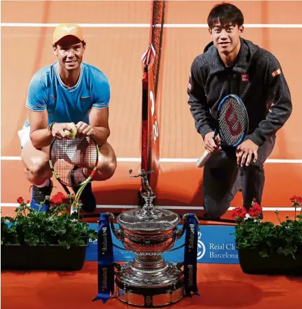  ?? — AFP ?? Smile: Spain’s Rafael Nadal (left) poses with Japan’s Kei Nishikori at the Palau de la Musica in Barcelona on Sunday on the sidelines of the Barcelona ATP Open tennis tournament.
